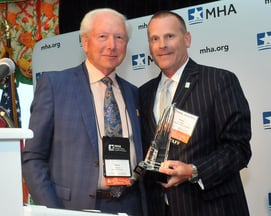 The photo feature Dennis with MHA CEO Brian Peters 