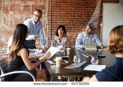 stock-photo-businesspeople-meeting-in-modern-boardroom-through-glass-547750285.jpg