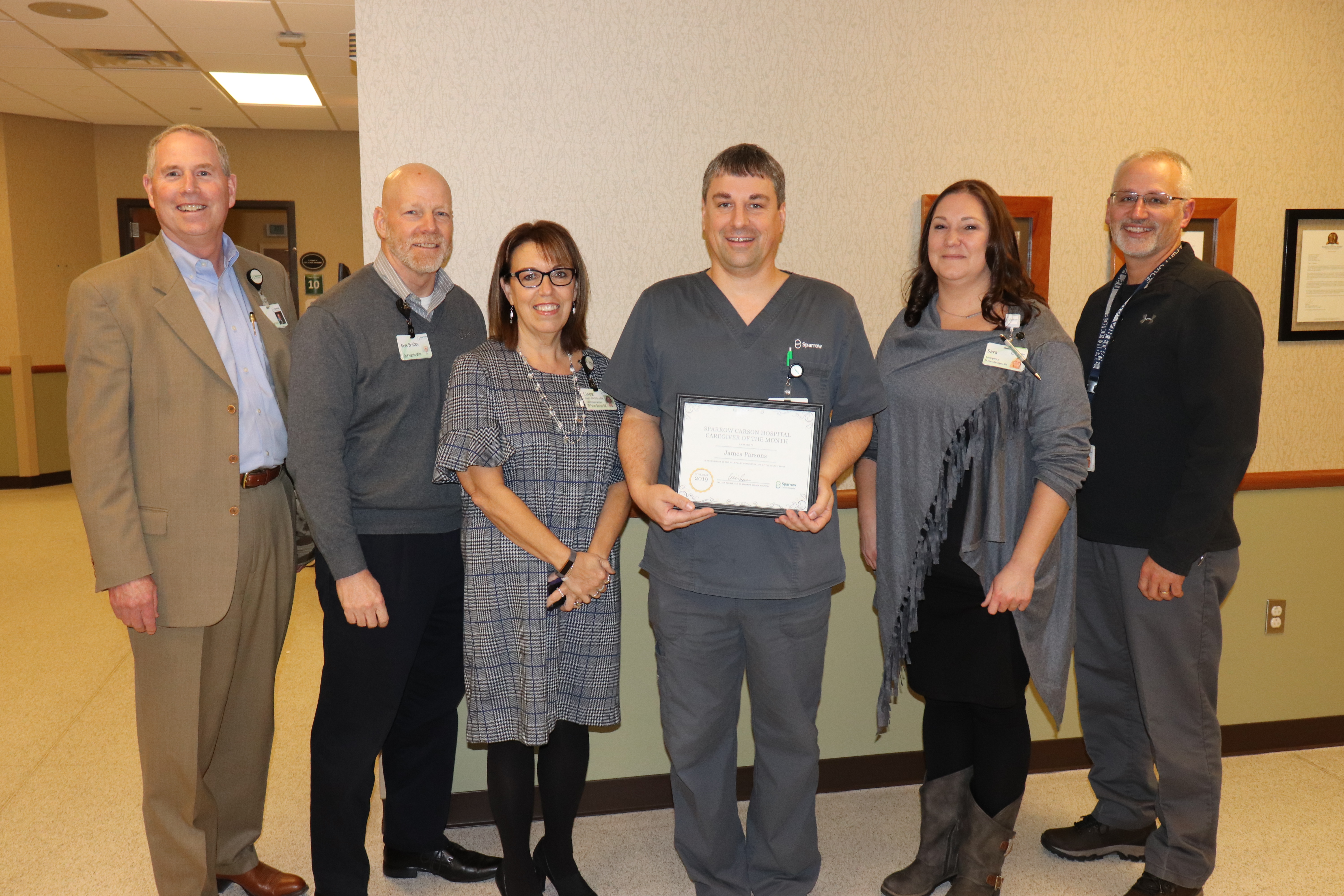 Photo caption: James Parsons, Emergency Department Paramedic (middle), received the Caregiver of the Month from Sparrow Carson Hospital Administrators Bill Roeser, President; Mark Brisboe, CFO; Linda Reetz, interim CNO; Sara Hagerman, Emergency Department Nurse Manager; and Monte Malek, Patient Care Services Director.