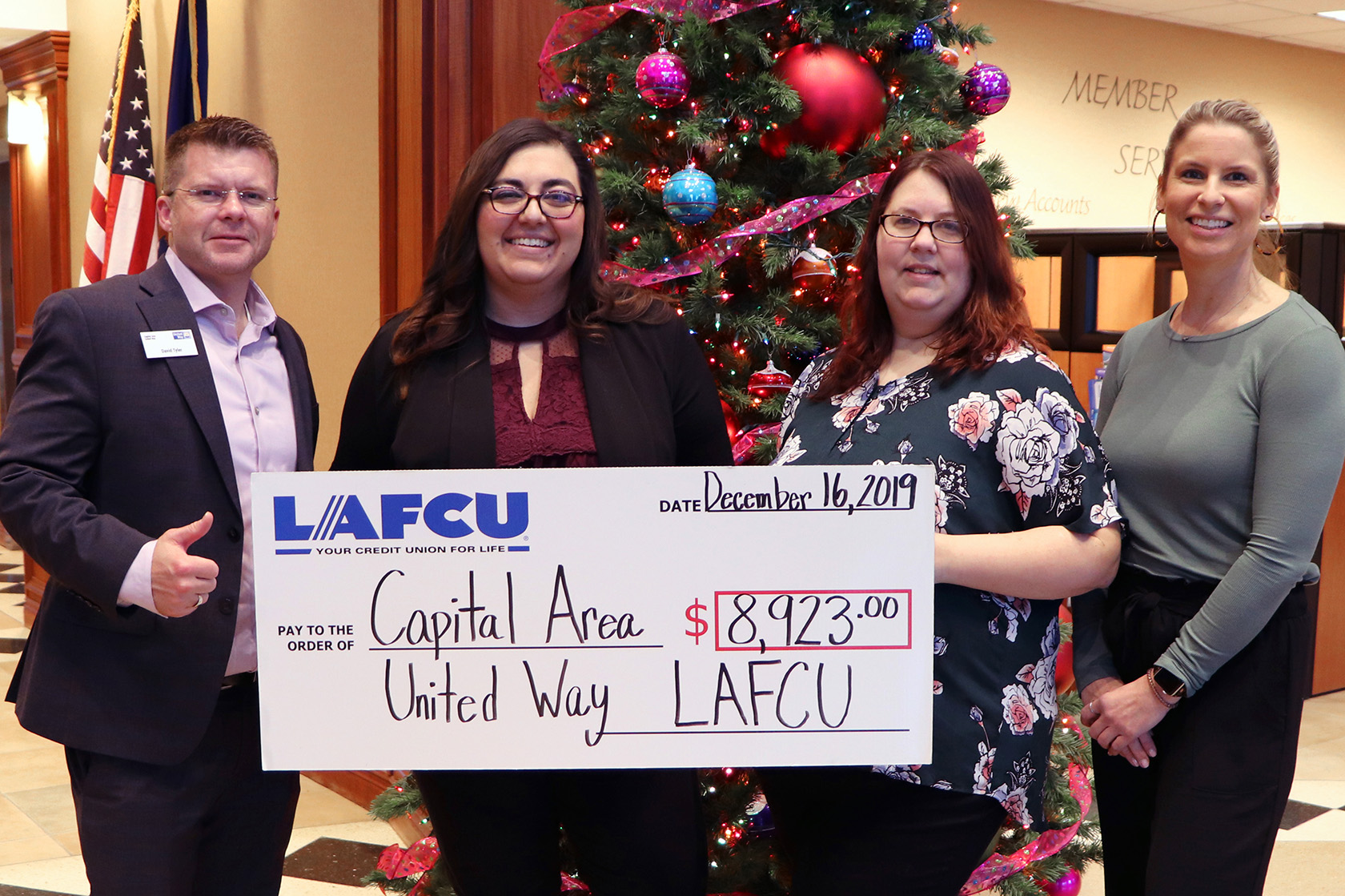 LAFCU-CAUW.jpg – From left, Capital Area United Way’s David Tyler accepts a ceremonial check for $8,923 from LAFCU Giving Committee members Amanda Seger, Teri and Suzi. Funds were raised internally at LAFCU through dress down days and other events in 2019.
